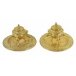 A pair of ornate gilt brass inkwells
circa 1880
each with foliate cast well with three mounted