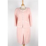 A pink Chanel wool skirt suit
single breasted jacket with pale pink satin trim, two pockets to