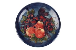 A large Moorcroft Blue Finches chargerdecorated with finches, leaves and berries on a blue