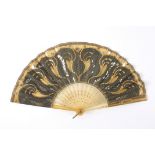 A horn bone and sequin fan
the horn guard sticks and sticks decorated with floral sprays, the