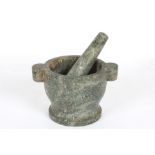 A large granite pestle and mortar
with carrying handlesDimensions: height 18cm., diameter