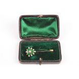 A Victorian diamond and enamel bar brooch
set with green enamel heart surrounded by seed pearls