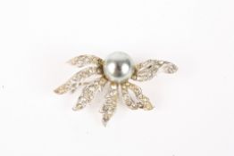 A Christian Dior floral brooch by Mitchel Maerset with simulated black pearl, surrounded by