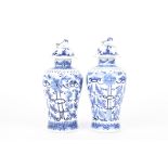 A small pair of 19th century Chinese blue and white vase and later covers
in the form of small