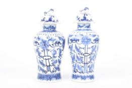 A small pair of 19th century Chinese blue and white vase and later coversin the form of small