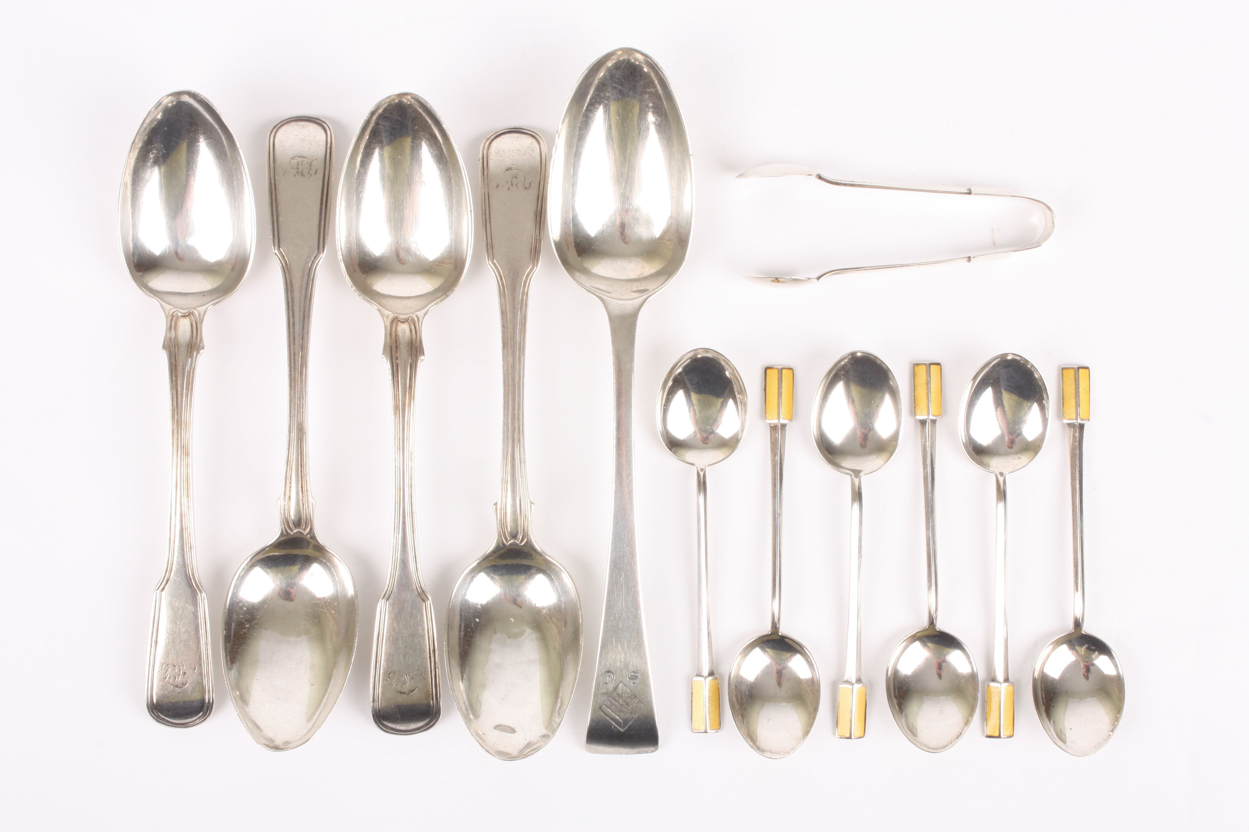A collection of silver spoons
comprising four Georgian silver spoons, a silver desert spoon, and six