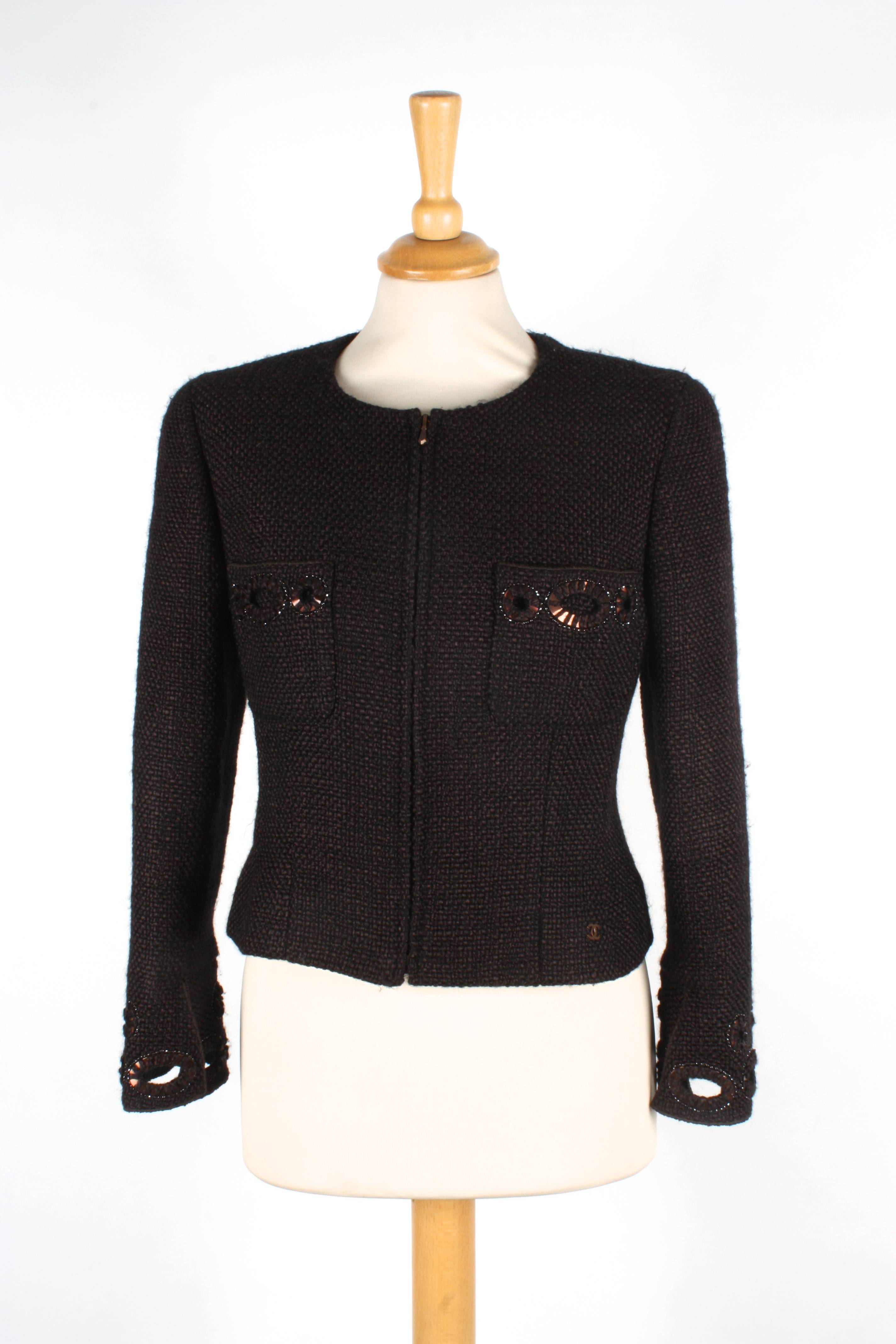 A brown Chanel wool jacket
with zip to front and two pockets to breast, with cut out patterns with