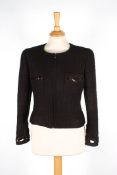 A brown Chanel wool jacketwith zip to front and two pockets to breast, with cut out patterns with