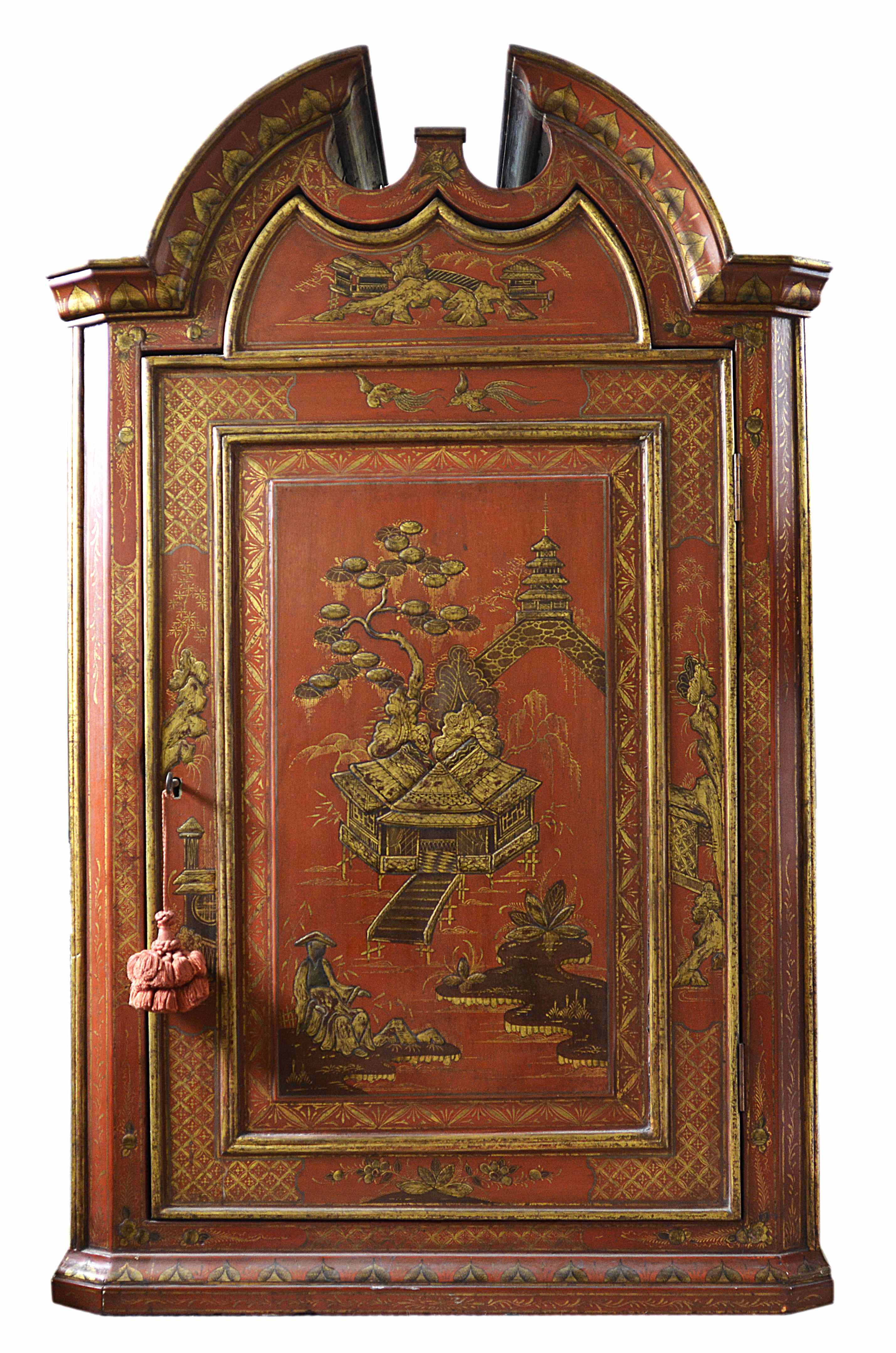 A Chinoiserie painted corner cupboard
the broken arched pediment over a single panel door opening to