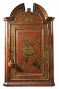 A Chinoiserie painted corner cupboardthe broken arched pediment over a single panel door opening to