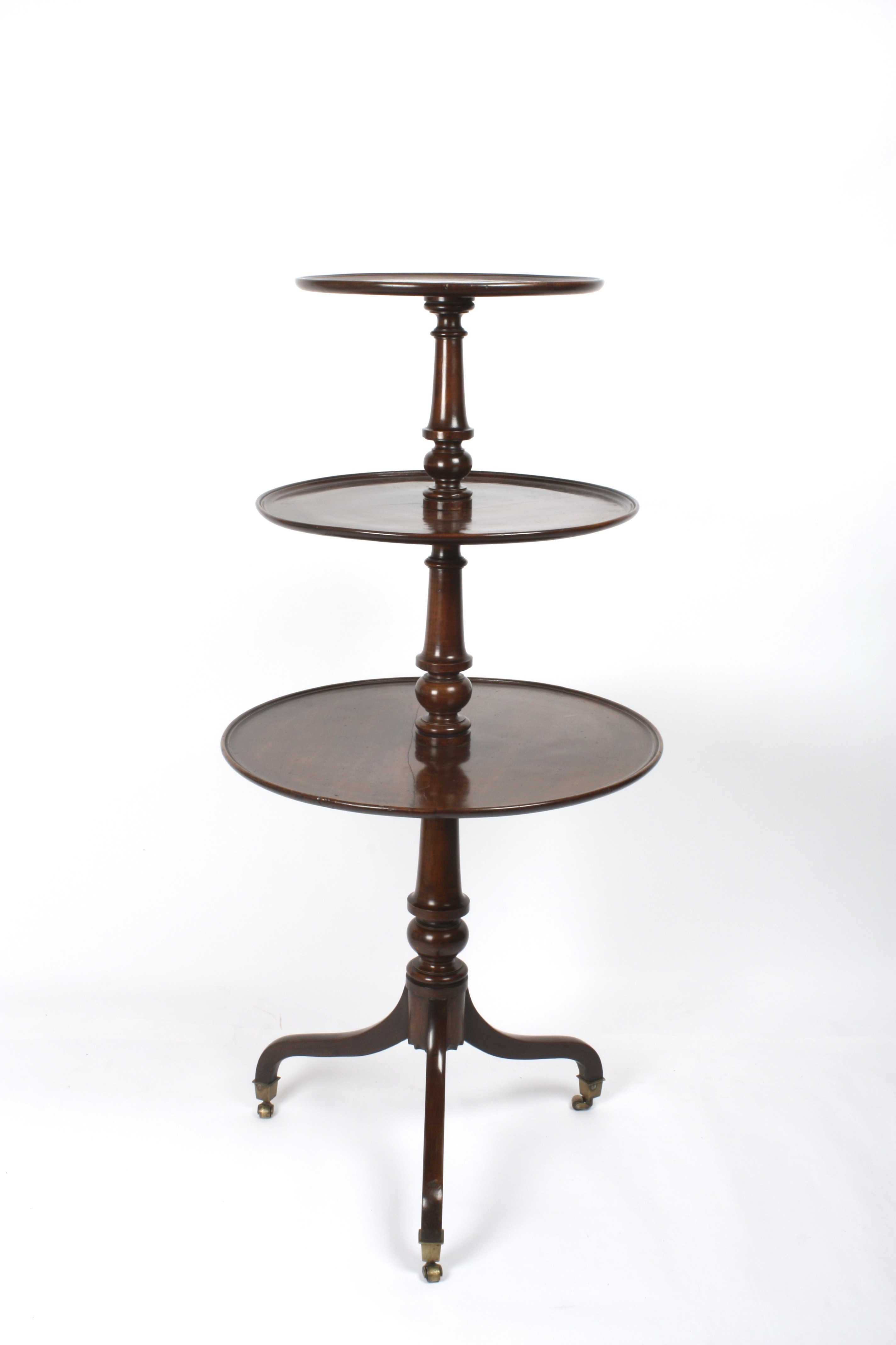 A George III mahogany three tier dumb waiter
with circular graduated tiers and turned columns,