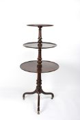 A George III mahogany three tier dumb waiterwith circular graduated tiers and turned columns,