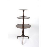 A George III mahogany three tier dumb waiter
with circular graduated tiers and turned columns,