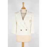 A Chanel ivory jacket
double breasted with gold coloured swirl patterned buttons, embroidered logo