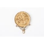 A George V 1915 22ct gold full sovereign
in a 9ct gold pendant mount.Dimensions: 9.4 grams.Condition