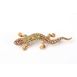 A charming Victorian 15ct gold peridot and seed pearl lizard brooch
in a naturalistic pose, set with