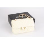 A leather quilted cream coloured Chanel handbag the leather double flap bag from Chanel featuring