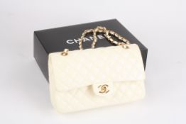 A leather quilted cream coloured Chanel handbag the leather double flap bag from Chanel featuring