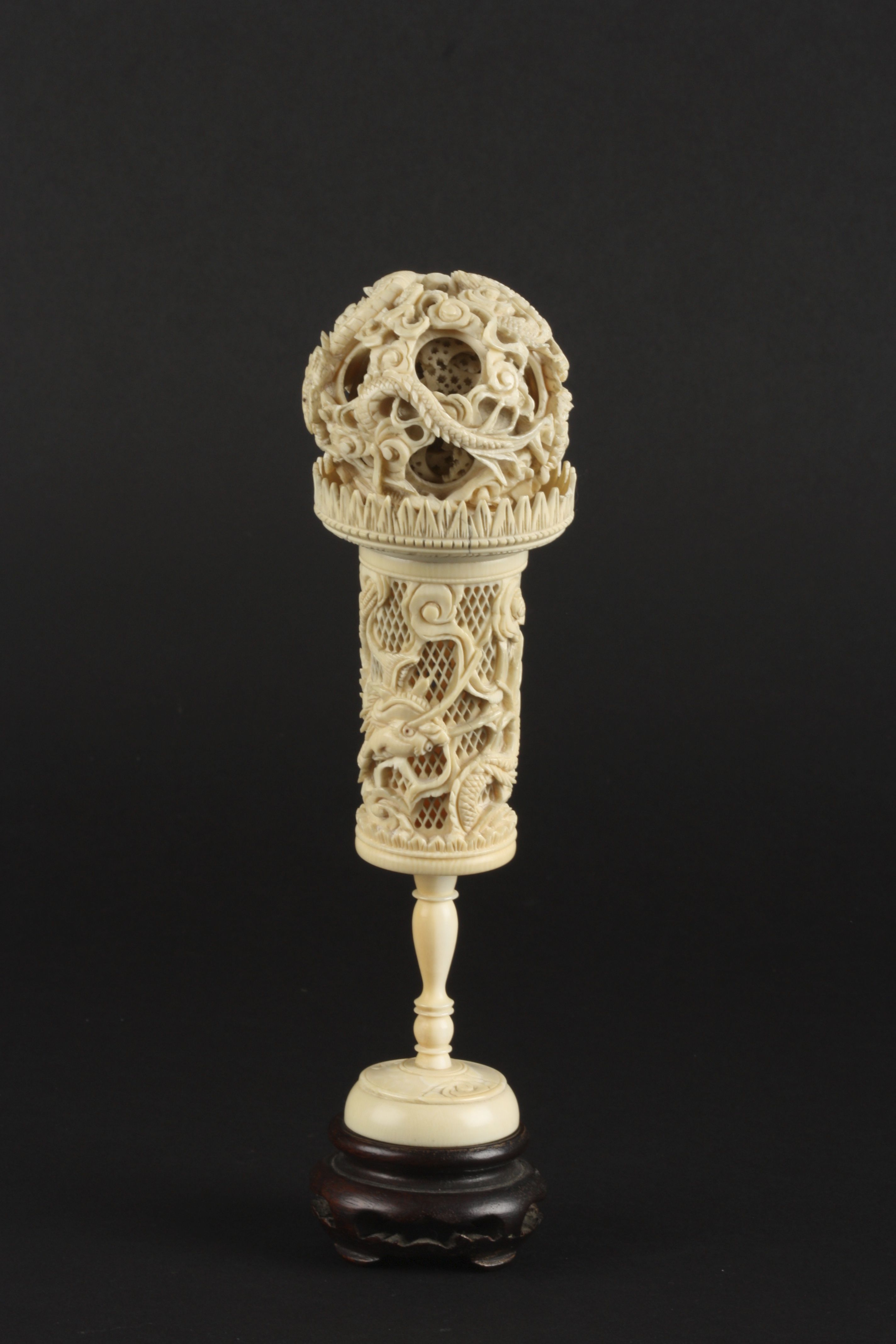 A Chinese ivory puzzle ball
late 19th/early 20th century
deeply carved with dragons, raised on