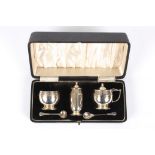 A George V silver cruet set
hallmarked Birmingham 1937, in a fitted case with blue glass liners,
