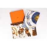 Two Hermès scarves, one in original box
the first predominantly navy and gold depicting signs of the