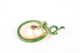 An early 20th century gold, enamel and ruby snake broochthe green enamel serpent with ruby set head