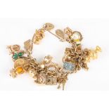A heavy 9ct gold charm bracelet
set with 32 charms of various types and a 1913 half sovereign.