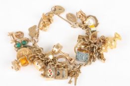 A heavy 9ct gold charm braceletset with 32 charms of various types and a 1913 half sovereign.