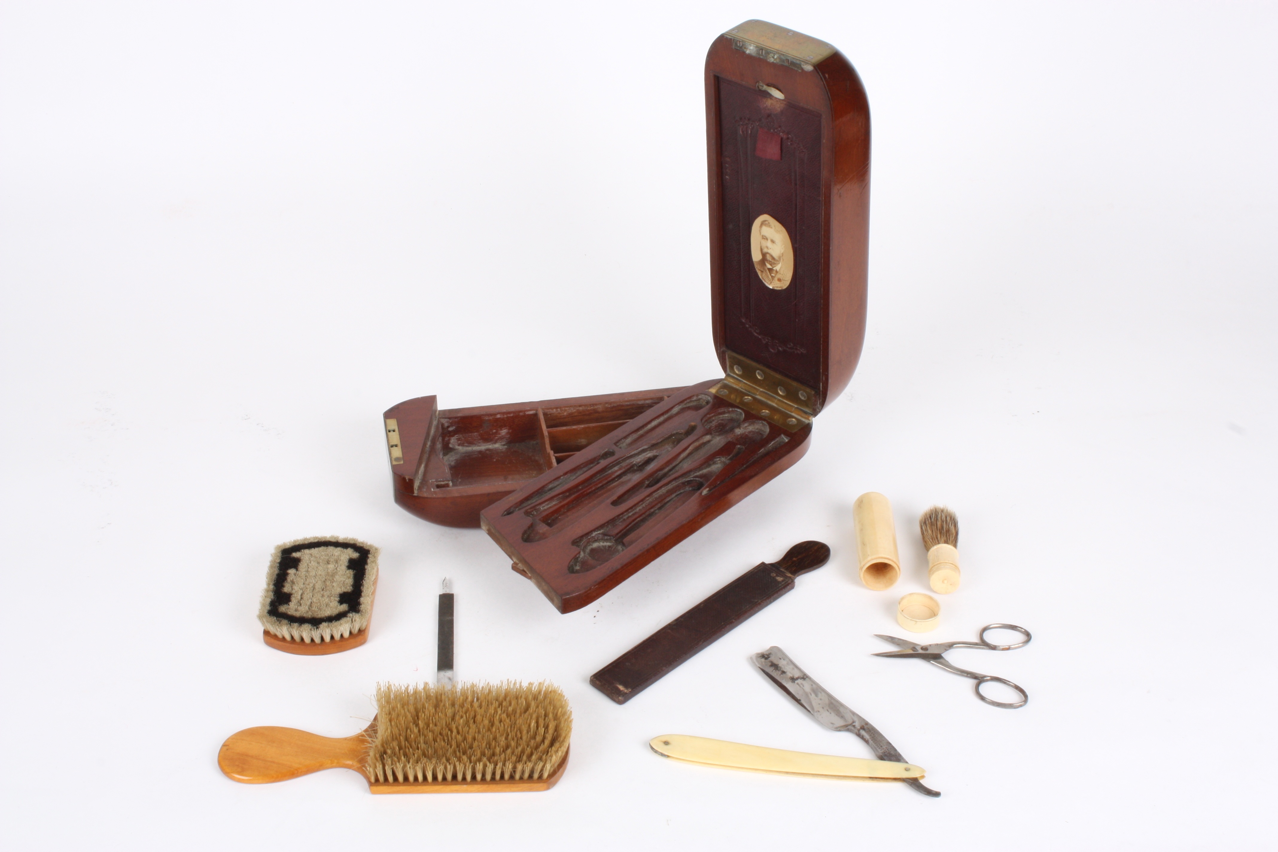 A gentleman's unusual 19th century mahogany cased travelling shaving set
the case of unusual shape - Image 2 of 3