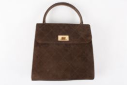 A small brown suede Chanel handbagof slightly tapered form with stitching in diamond patterns, gold