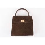 A small brown suede Chanel handbag
of slightly tapered form with stitching in diamond patterns, gold