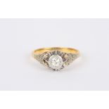 A gold coloured metal and silver diamond ring
with single diamond in coronet setting, and chased