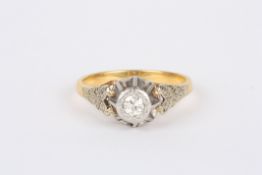 A gold coloured metal and silver diamond ringwith single diamond in coronet setting, and chased