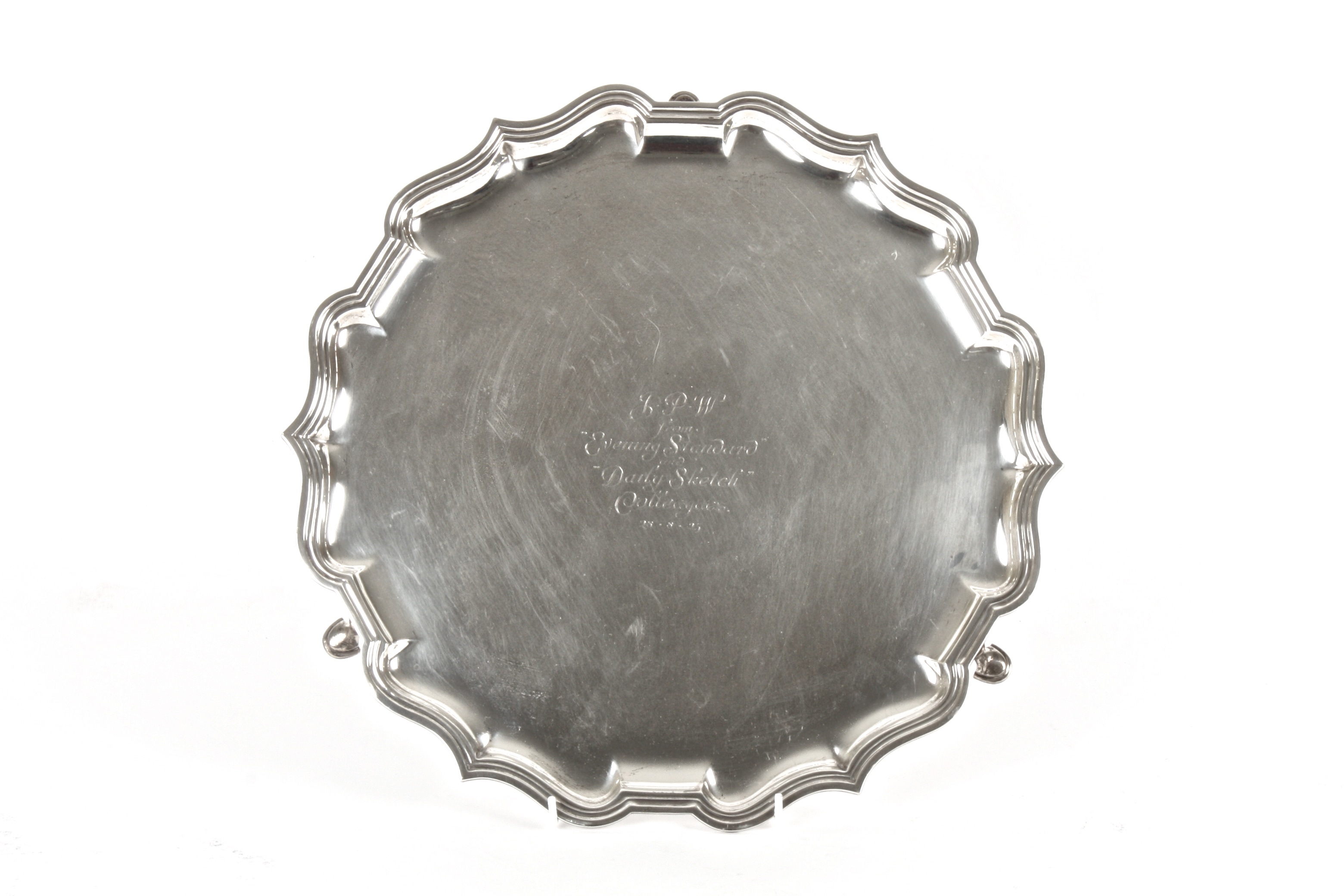 A silver pie crust tray
hallmarked Birmingham 1924, Elkington and raised on three hoof feet, with