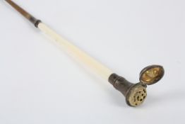 A 19th century riding crop with white metal vinaigrettewith ivory upper section surmounted by white