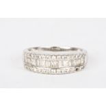 An 18ct white gold and diamond half eternity ring set with a row of alternating baguette and