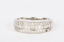 An 18ct white gold and diamond half eternity ring set with a row of alternating baguette and