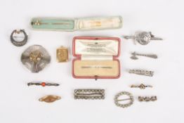 A small collection of brooches, locket and two pinssome of the brooches are marked silver and