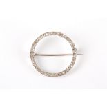 An early 20th century diamond circular brooch
of elegant and simple form, the circle mounted all