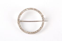 An early 20th century diamond circular broochof elegant and simple form, the circle mounted all