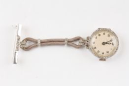 An 18ct white gold nurses fob watchthe silvered dial, surrounded by a diamond chip bezel and