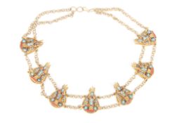 A Tibetan necklacethe chain interspersed with mask shaped heads inset with turquoise and coral