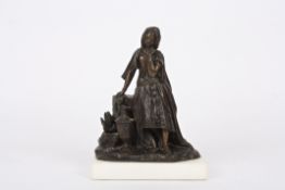 A 19th Century French bronze girlstood wearing flowing robes stood beside a rocky pedestal and a