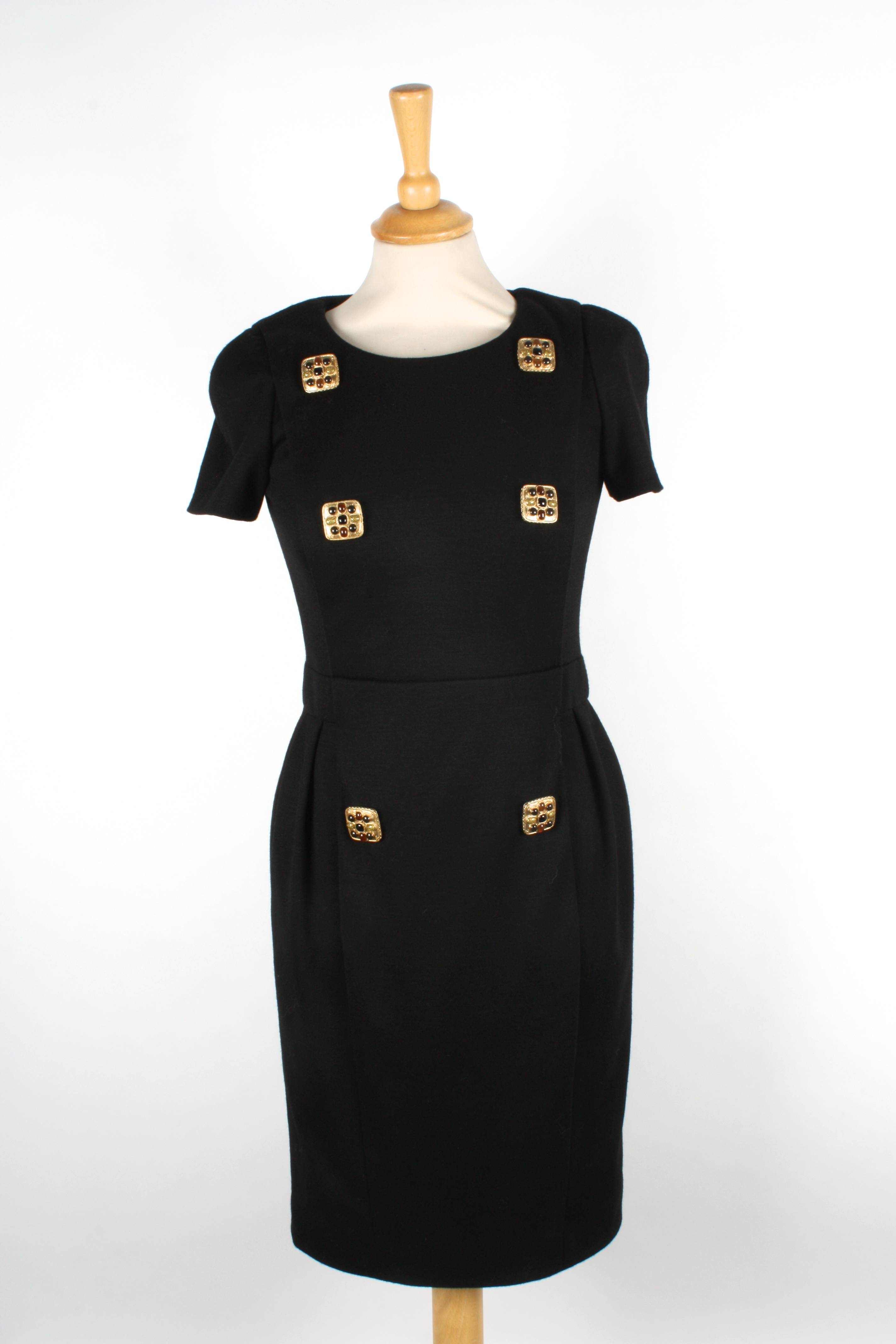 Two Chanel dresses
the first wool black dress with short sleeves, and six gilt beaded buttons to