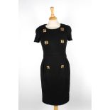 Two Chanel dresses
the first wool black dress with short sleeves, and six gilt beaded buttons to