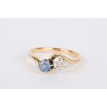 A gold coloured metal, diamond and sapphire two stone ring
set with diamond weighing approximately