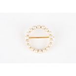 An Edwardian 15ct gold and pearl brooch
of plain circular form, mounted with eighteen pearls on a