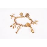A 9ct gold charm bracelet the curb link bracelet with 8 charms including, aeroplane, dog, brush comb