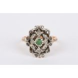 A 19th century Continental diamond and emerald ring
of shield form with centre emerald surrounded by