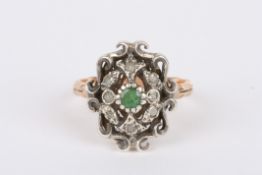 A 19th century Continental diamond and emerald ringof shield form with centre emerald surrounded by